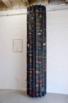 Painting of colored written words fragments on a black surface creating a column, by artist Patricia Sandonis