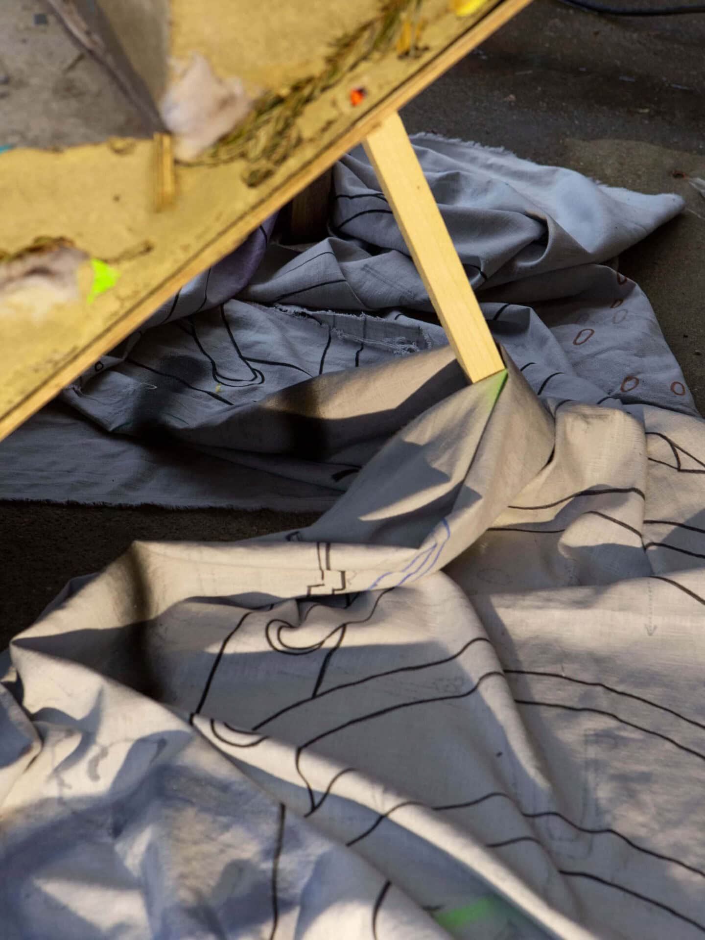 Detail from the art installation Hard Core, Soft Edges by conceptual artists Patricia Sandonis and Jelena Fuzinato showing a painting on linen fabric on the floor