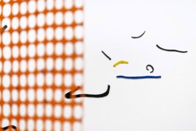 Glazed ceramic forms on a wall, an art installation called Very Important by artist Patricia Sandonis at Museo Patio Herreriano