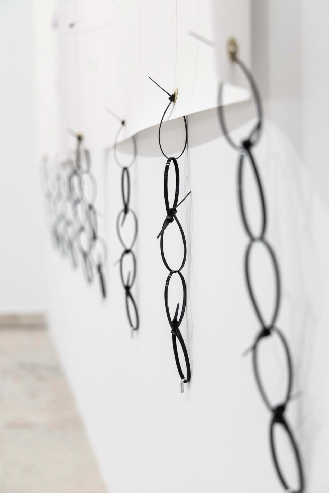 Cable ties forming a chain of plastic at the artwork called Super important by conceptual artist Patricia Sandonis