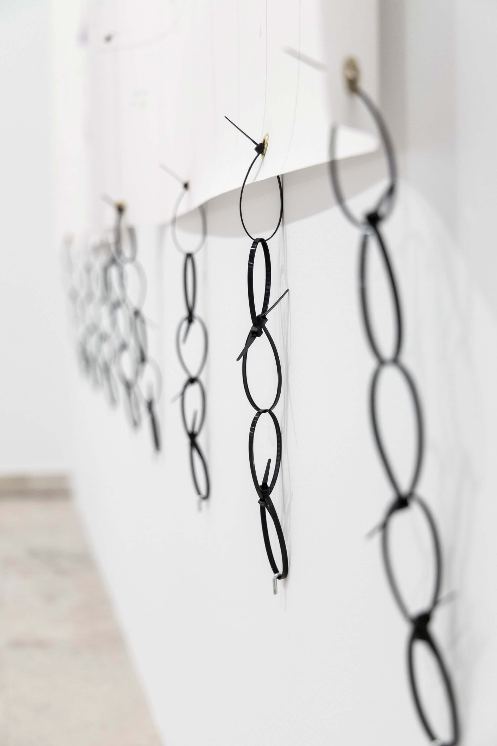 Cable ties forming a chain of plastic at the artwork called Super important by conceptual artist Patricia Sandonis