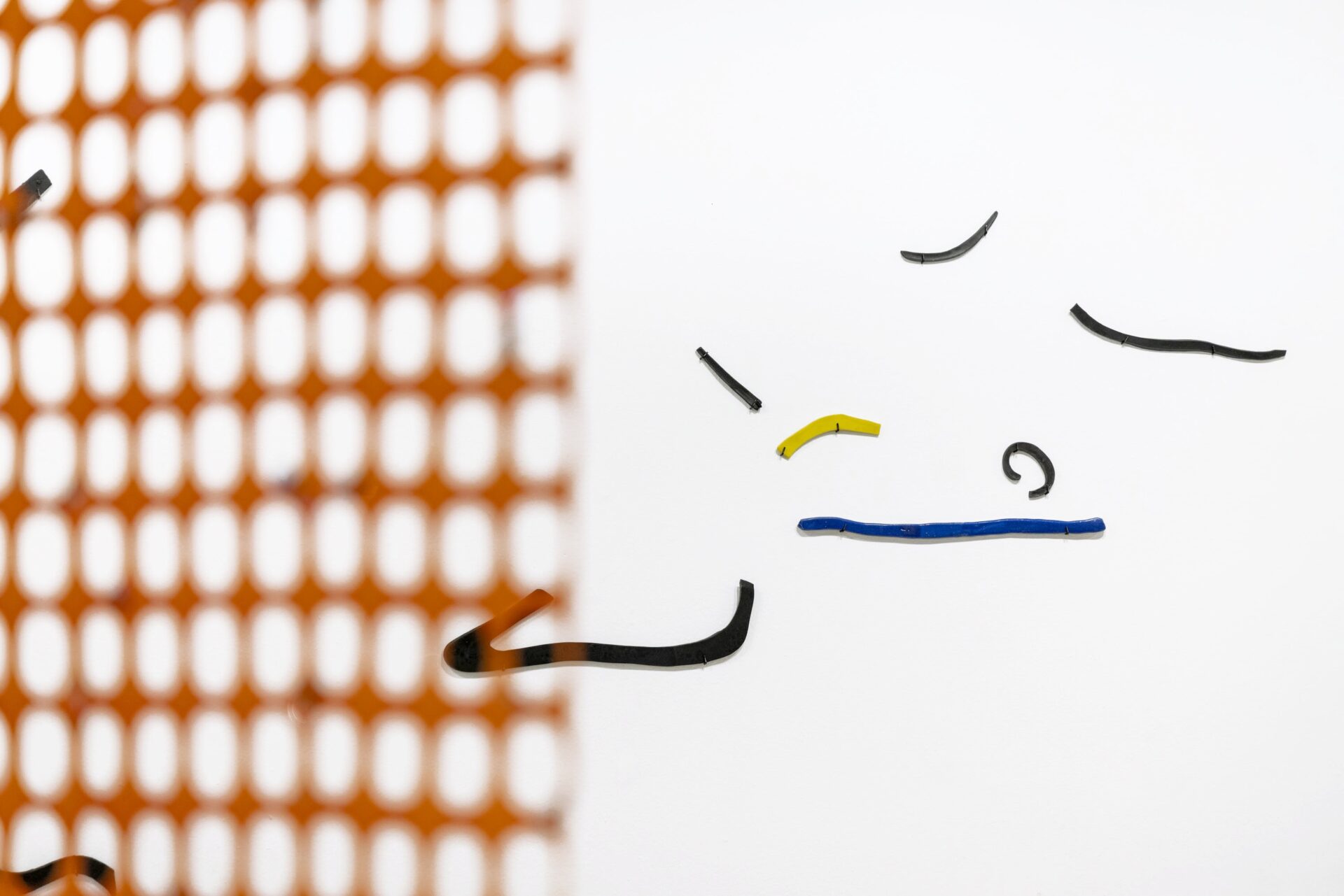 Glazed ceramic forms on a wall, an art installation called Very Important by artist Patricia Sandonis at Museo Patio Herreriano