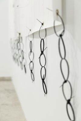 Cable ties forming a chain of plastic at the artwork called Super important by conceptual artist Patricia Sandonis