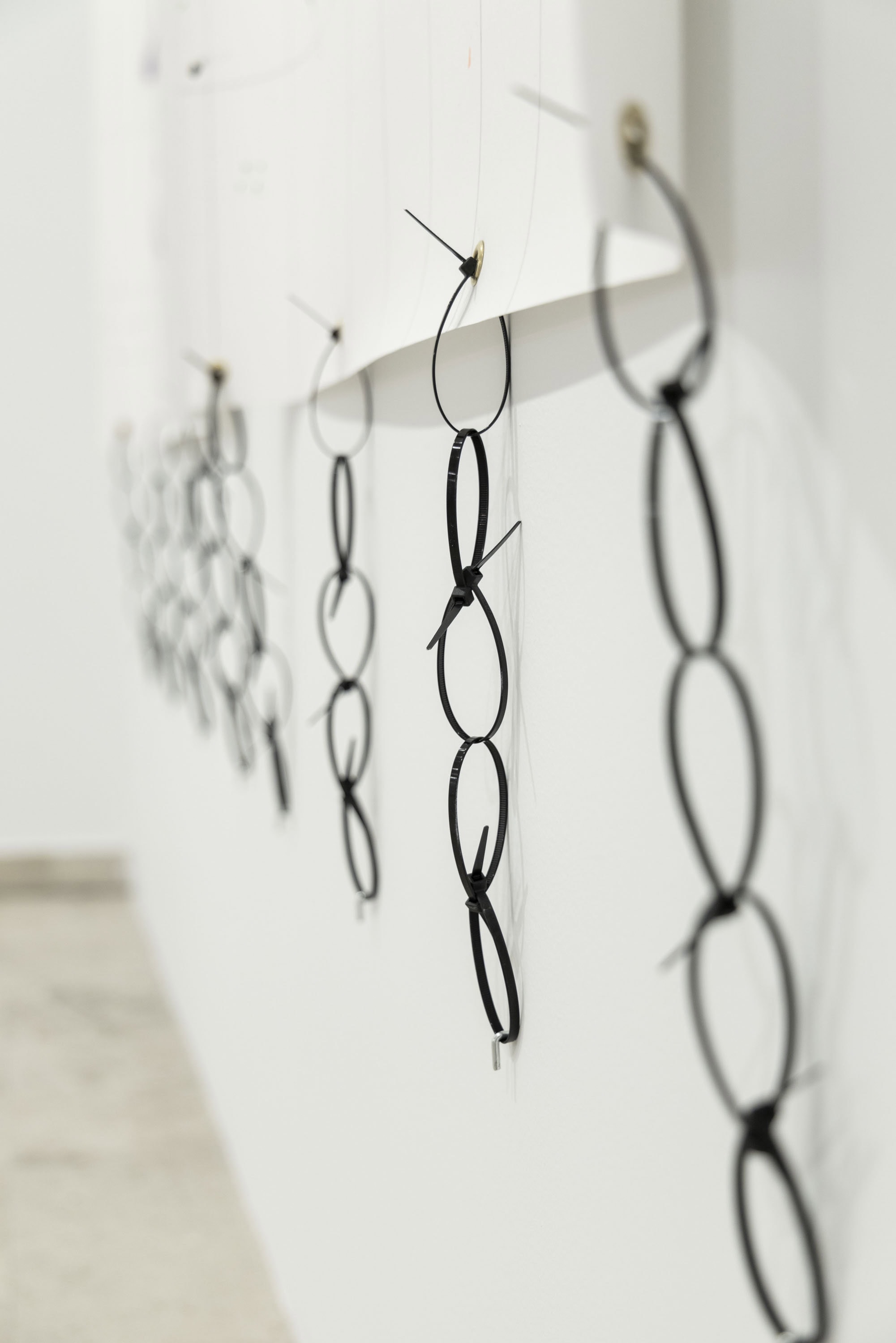 Cable ties forming a chain of plastic at the artwork called Super important by conceptual artist Patricia Sandonis