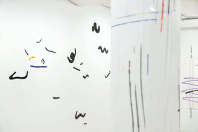 Art installation with handmade glazed ceramics on an exhibition wall by the artist Patricia Sandonis