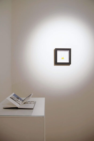 Patricia Sandonis, Fortuna Populi an art installation consisting of an artist book and a lucky charm in a black frame, Spanish Embassy in Berlin