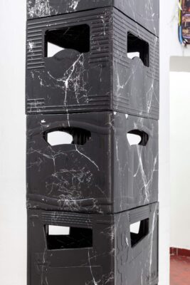 Patricia Sandonis art installation detail, a readymade of black marbleized beer crates set up as a column