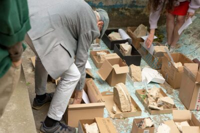 Small sculptures in cardboard boxes to take away by people during the closure event of the art exhibition Promising Premises at Bärenzwinger art space, Berlin