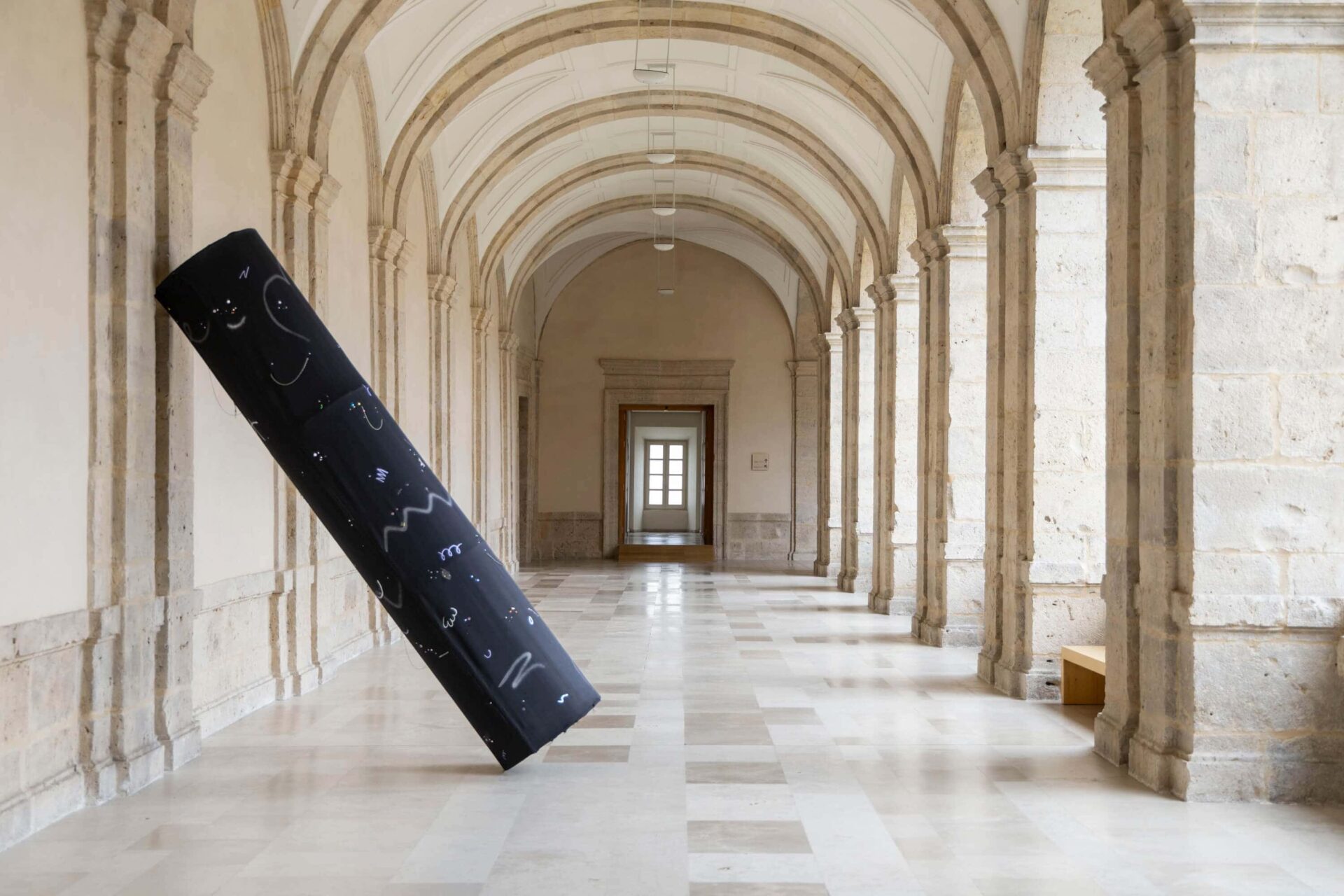 Art Installation Ignored in Public by conceptual artist Patricia Sandonis showing a big-format black column sculpture in Museo Patio Herreriano