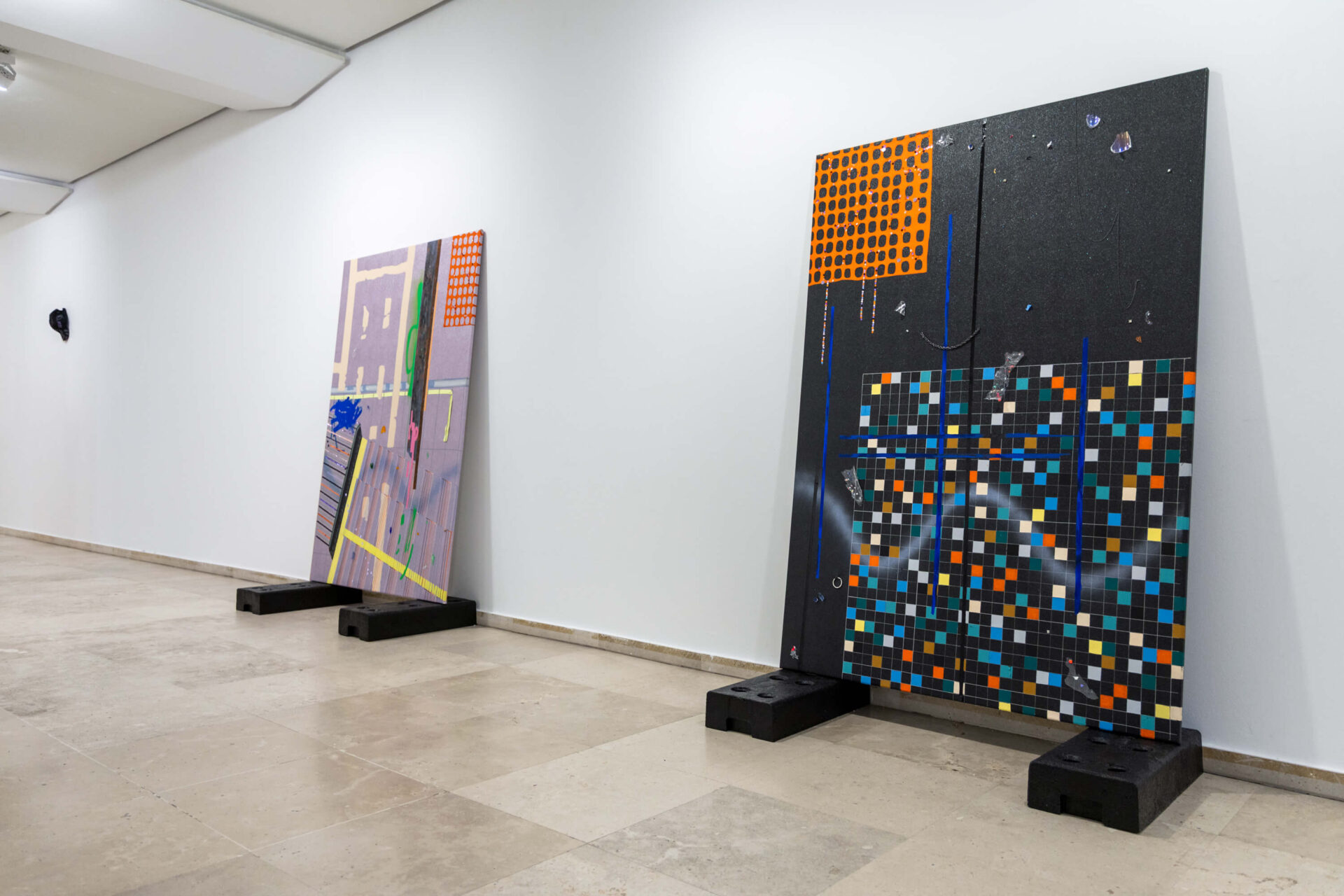 Two big-format paintings on fence feet called Keep Up Appearances by artist Patricia Sandonis, shown at an art exhibition in Museo Patio Herreriano