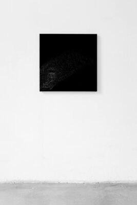 Black square painting hanging on a white wall by artist Patricia Sandonis