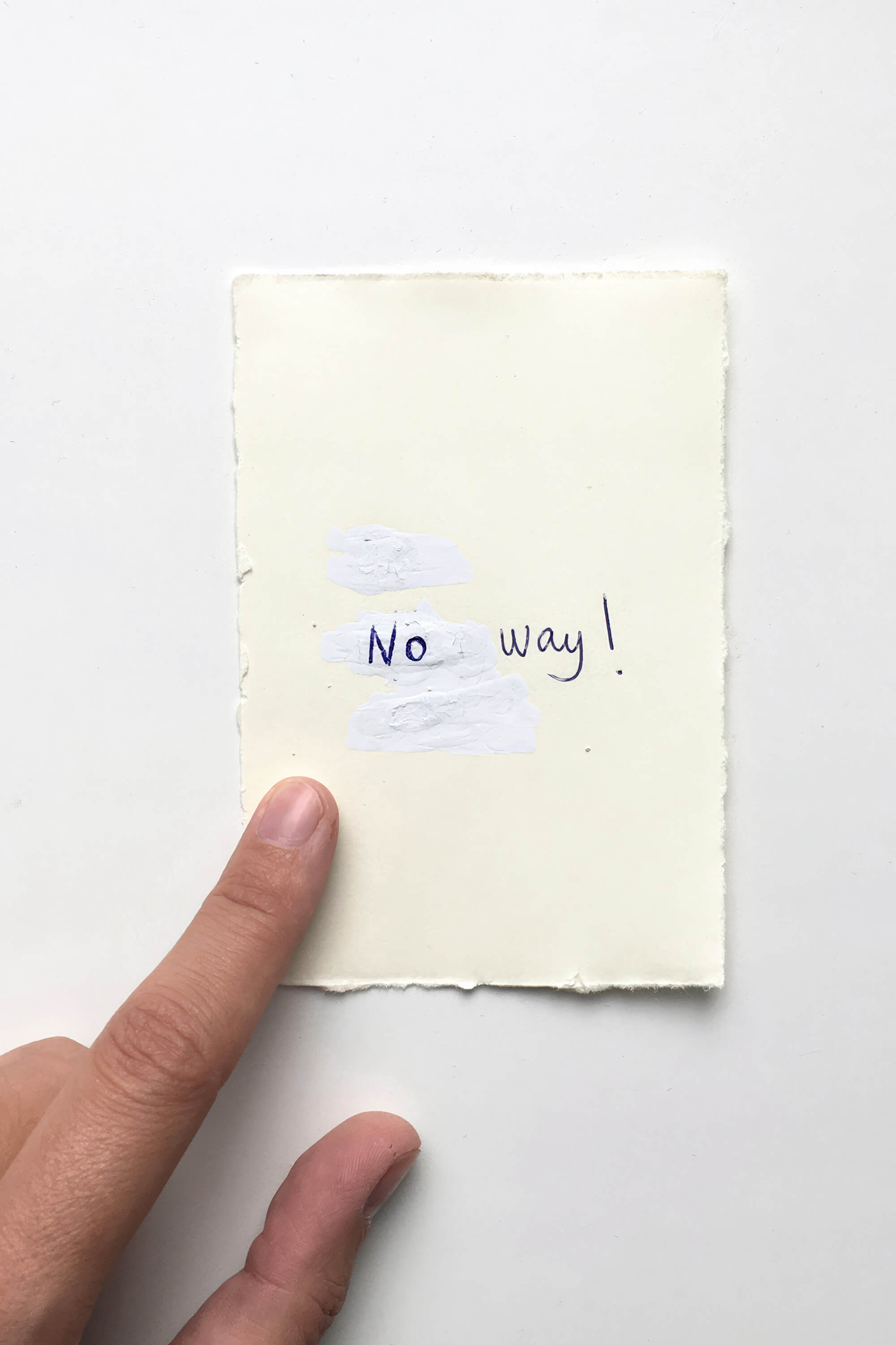 Finger pointing a small drawing written on paper saying No way! by artist Patricia Sandonis