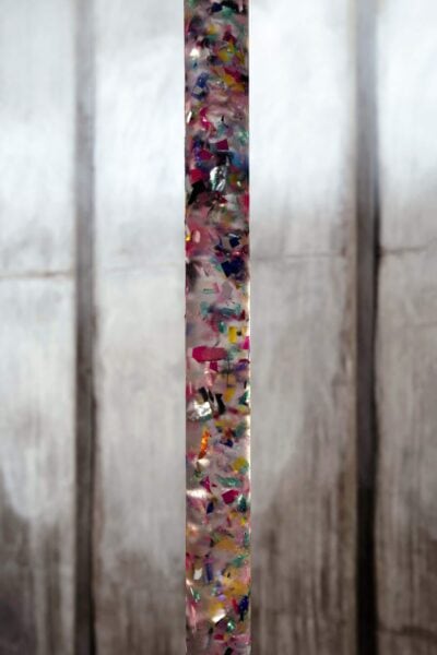 Sculpture of plastic and crystal clear with the form of a colored tube by artist Patricia Sandonis