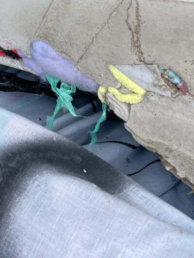 Remnants of plastic in concrete and painting on linen, material detail from the art installation Hard Core, Soft Edges by artists Patricia Sandonis and Jelena Fuzinato