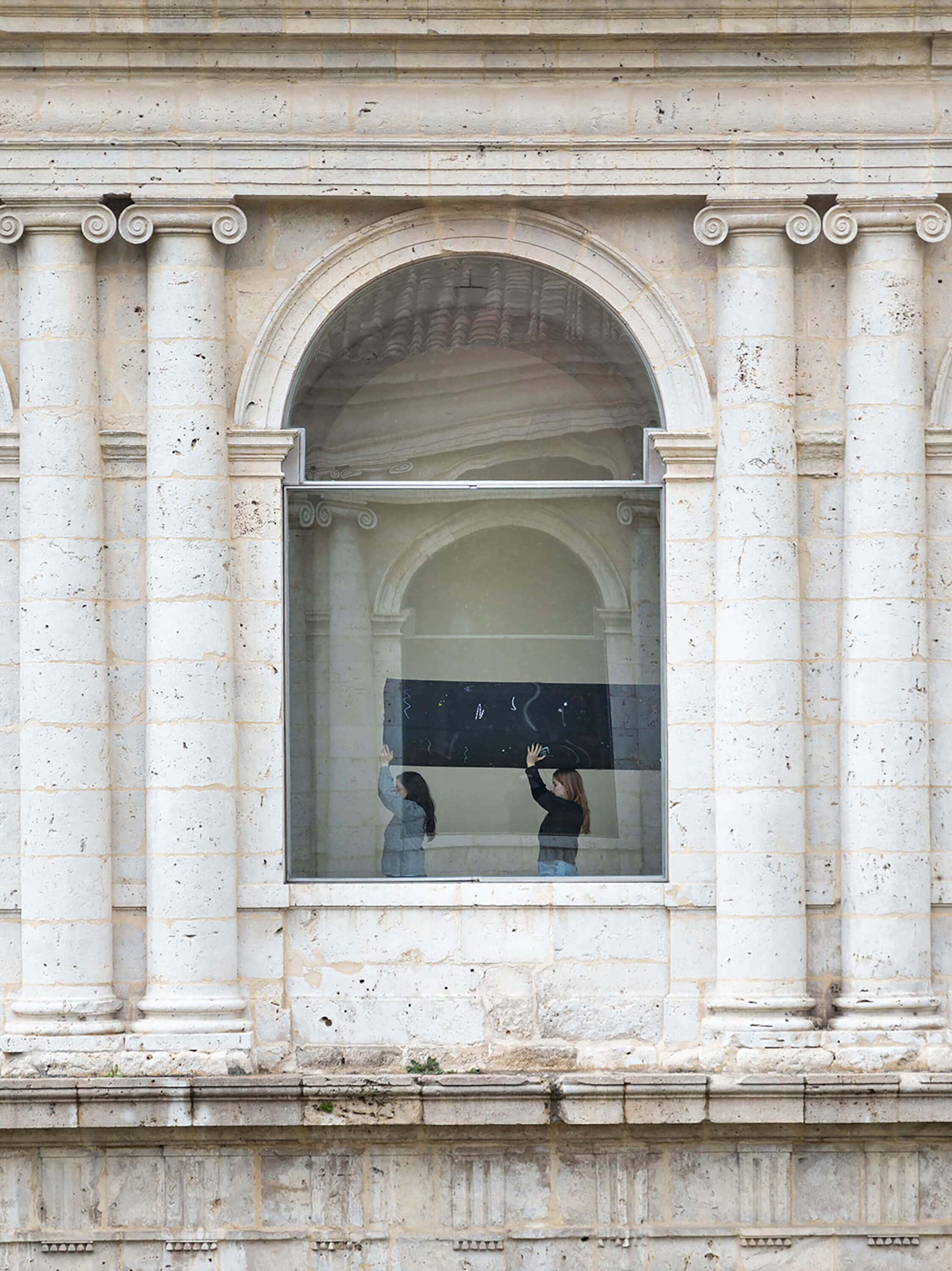 Performance by artist Patricia Sandonis at Museo Patio Herreriano carrying a sculpture in procession