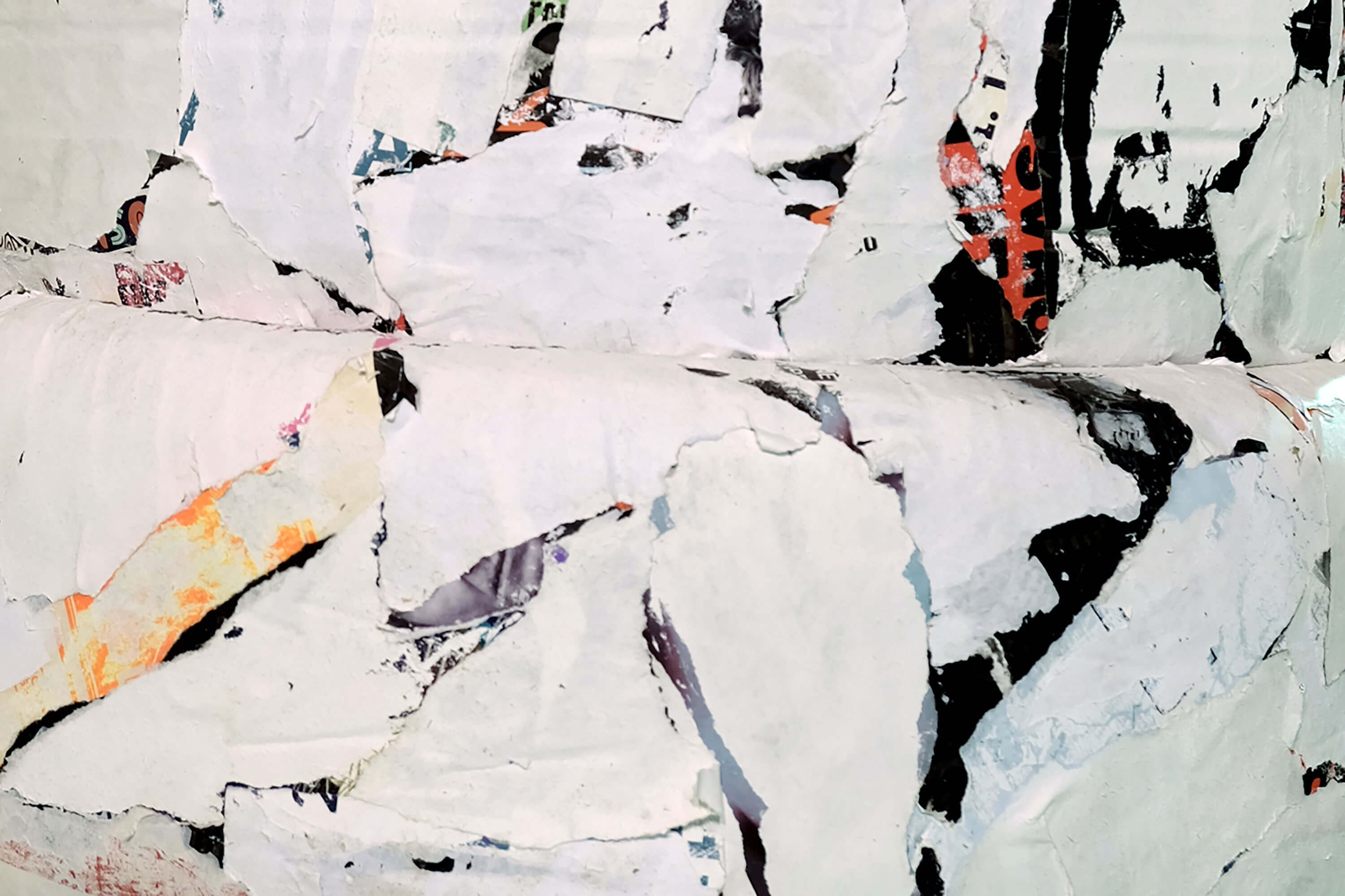 Patricia Sandonis art installation detail, showing fragments of black and white paper on car tires forming a column.