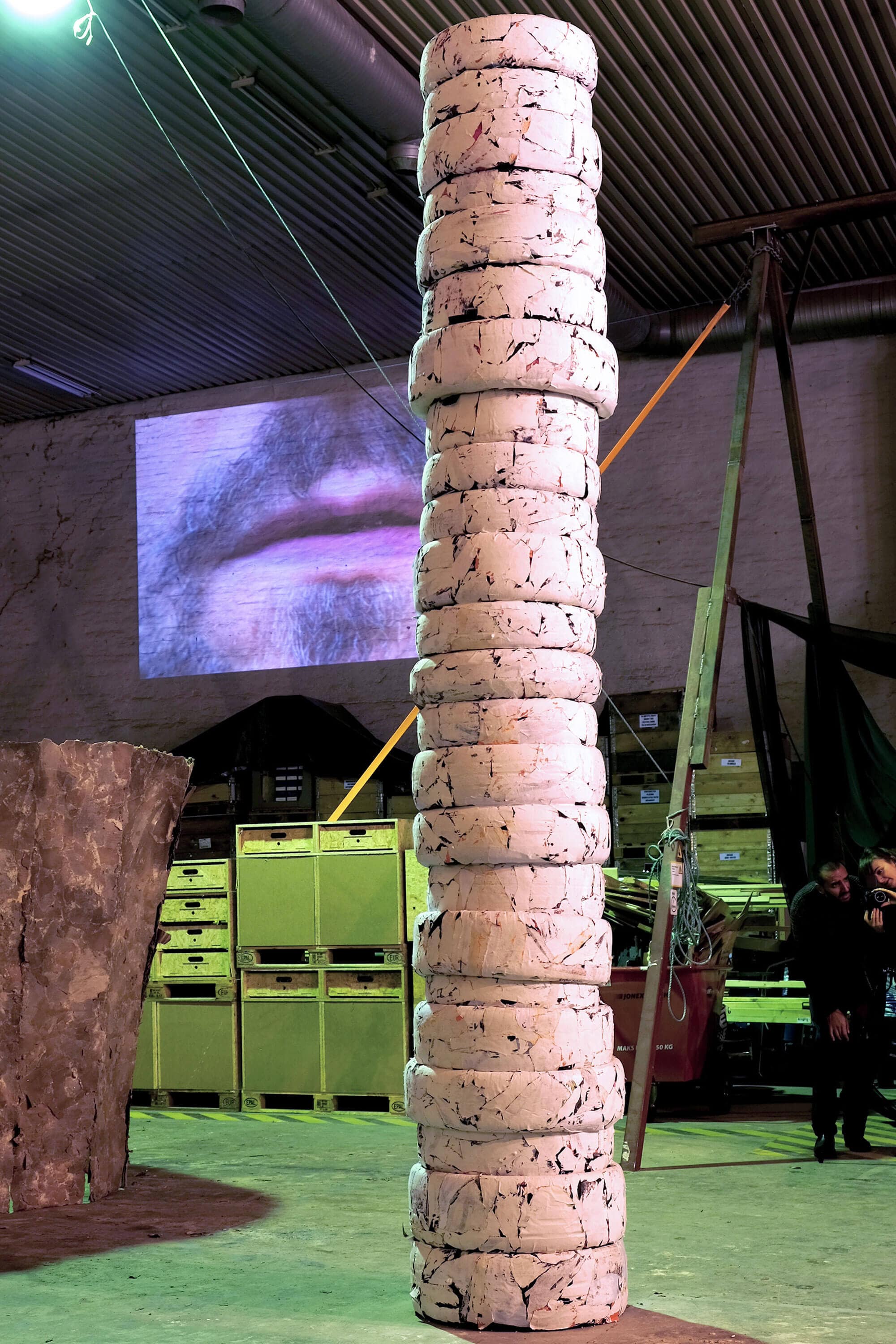 Patricia Sandonis art installation titled Photo Until it Becomes Marble, showing a big-format white column made out of car tires